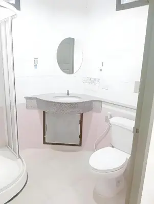 a white bathroom with a sink and a toilet at XX Mitr Inn Sukhumvit 2 - มิตร อินน์ สุขุมวิท 2 in Bang Kapi
