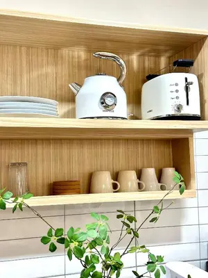 a shelf with a toaster and cups on it at Spacious 2BR2BA in Thonglor with WiFi & balcony in Khlong Toei