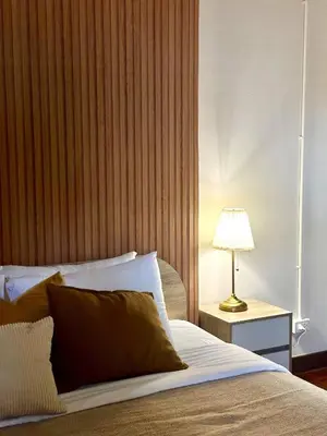 a bedroom with a bed and a lamp on a table at Spacious 2BR2BA in Thonglor with WiFi & balcony in Khlong Toei