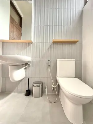 a bathroom with a toilet and a sink at Spacious 2BR2BA in Thonglor with WiFi & balcony in Khlong Toei