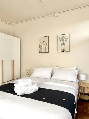 a bedroom with a bed with a black and white blanket at Spacious 2BD 2BA Apartment in Thong Lor in Khlong Toei