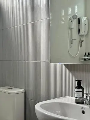 a bathroom with a sink and a shower and a toilet at Spacious 2BD 2BA Apartment in Thong Lor in Khlong Toei