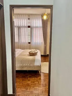 a bedroom with a bed and a window at Spacious 2BD 2BA Apartment in Thong Lor in Khlong Toei