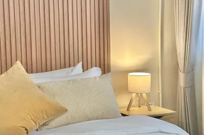 a bedroom with a bed and a lamp on a table at Spacious 2BD 2BA Apartment in Thong Lor in Khlong Toei