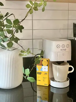 a coffee maker sitting on a counter next to a vase at Spacious 2BD 2BA Apartment in Thong Lor in Khlong Toei