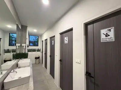 a bathroom with two sinks and two toilets at City Pause Hostel in Sathani Bang Su