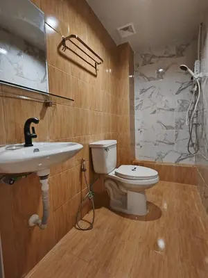 a bathroom with a sink and a toilet at D45 Home - BTS Ratchathewi N1 Station in Bangkok