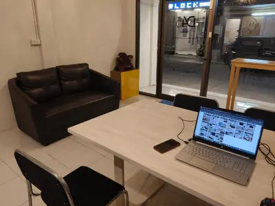 a table with a laptop computer on top of it at D45 Home - BTS Ratchathewi N1 Station in Bangkok