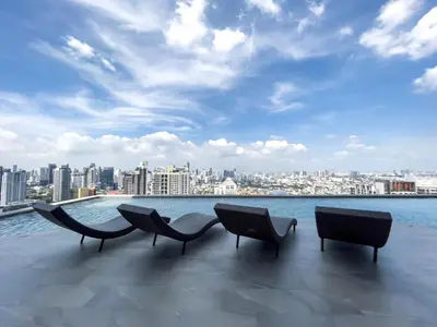 three chairs sitting on top of a building overlooking the water at 250m BTS l Duplex Unit l Rooftop Pool l Sontana in Bangkok