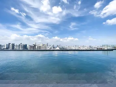 a large body of water with a city in the background at 250m BTS l Duplex Unit l Rooftop Pool l Sontana in Bangkok