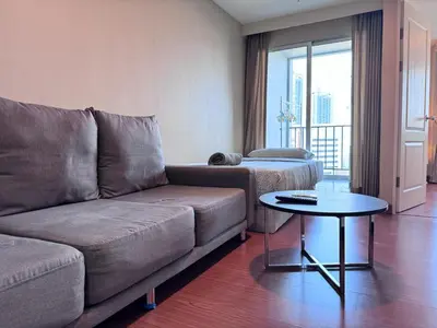 a living room with a couch and a table at Sky Apartment - Pool - BTS - Gym - Sauna in Bangkok