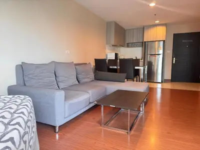 a living room with a couch and a table at Sky Apartment - Pool - BTS - Gym - Sauna in Bangkok