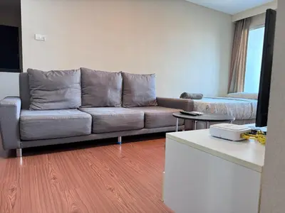 a living room with a couch and a table at Sky Apartment - Pool - BTS - Gym - Sauna in Bangkok