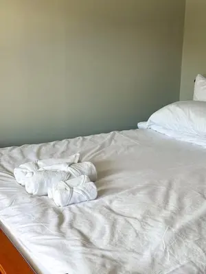 a bed with three folded towels on it at Pridi cozy home with good location Type C in Bangkok