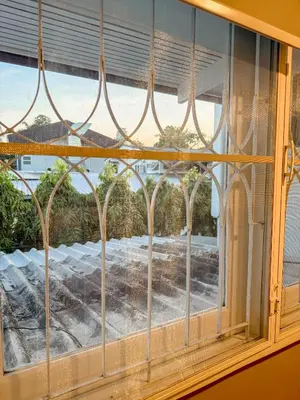 a window with a view of a yard at Pridi cozy home with good location Type C in Bangkok