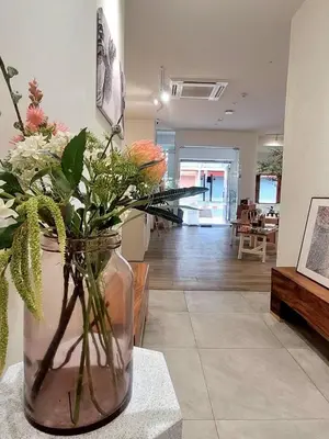 a vase filled with flowers on a table in a room at BubbleHumbleBangkok in Bangkok