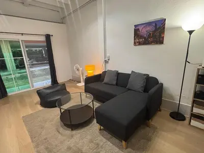 a living room with a couch and a table at Siam Central 2BR Yumi house Near IconSiam in Bangkok