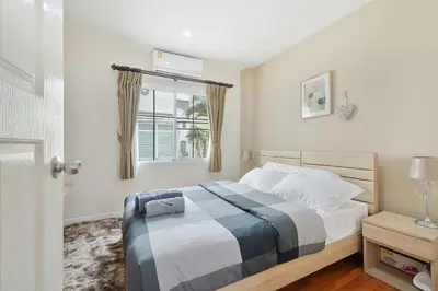 a bedroom with a bed and a window at Modern 3BR Rama Mansion Near Airport plus Amenities in Sathani Ban Hua Mak