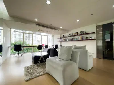 a living room with a white couch and a table at 150m to BTS l Workspace l Pool and Gym l Sontana in Bangkok