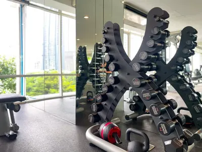 a gym with a rack of wine bottles at 150m to BTS l Workspace l Pool and Gym l Sontana in Bangkok