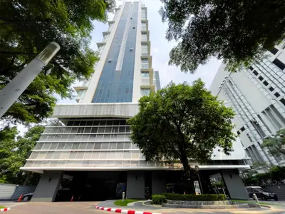 a tall building with a tree in front of it at 150m to BTS l Workspace l Pool and Gym l Sontana in Bangkok