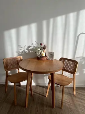 a wooden table with two chairs and a vase on it at Free Wi-Fi Private Room I Near the Mall Bangkapi in Bangkok