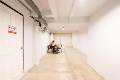 a person sitting at a table in an empty room at XX Mitr Khaosan Bangkok in Bangkok