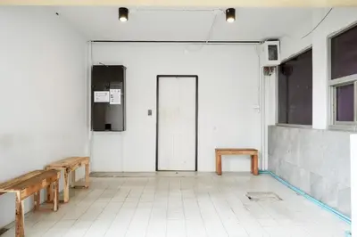 an empty room with benches and a door at XX Mitr Khaosan Bangkok in Bangkok