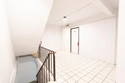a staircase in a white room with a glass door at XX Mitr Khaosan Bangkok in Bangkok