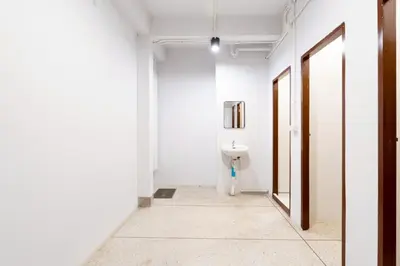 a hallway with a sink in a white room at XX Mitr Khaosan Bangkok in Bangkok