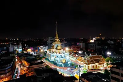 a lit up city at night with a large building at XX GO INN MRT Hua Lamphong - วัดไตรมิตร in Samphanthawong