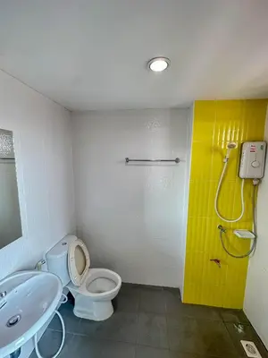 a bathroom with a toilet and a sink and a shower at Nuanchan Apartment in Ban O Pao