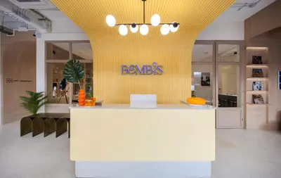 a store with a yellow wall with a barrets sign on it at Bembis Hotel Charoenakorn 10 in Chinatown