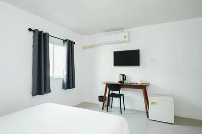 a bedroom with a bed and a desk and a television at SleepPop Sukhumvit 42 - BTS Ekkamai in Phra Khanong