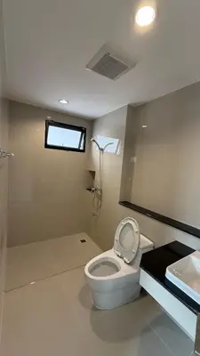 a bathroom with a toilet and a sink at Nene Apartment in Ban Bang Talat