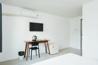 a room with a table and a tv on a wall at XX SleepPOP Sukhumvit 42 - BTS Ekkamai Station - Bangkok in Phra Khanong