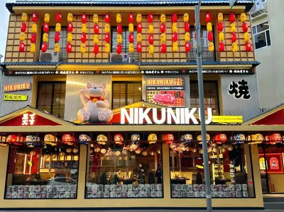 a building with a nikimaru sign on top of it at XX SleepPOP Sukhumvit 42 - BTS Ekkamai Station - Bangkok in Phra Khanong