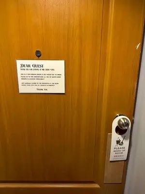 a sign on a door with a sign on it at MrchowRoom in Bangkok