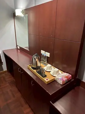 a table with a tray with a tea kettle on it at MrchowRoom in Bangkok