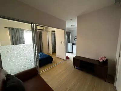 a room with a mirror and a bed and a couch at Plum condo Bang-yai station in Nonthaburi