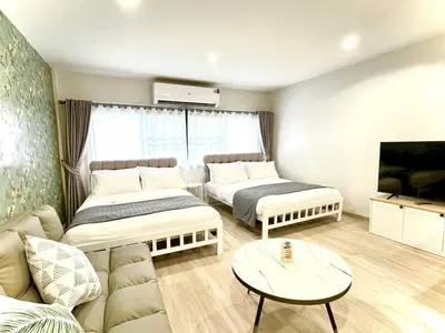 a living room with two beds and a couch at New Apt, Near Siam Paragon, 2 Min to BTS 1BR,4Pax in Bangkok