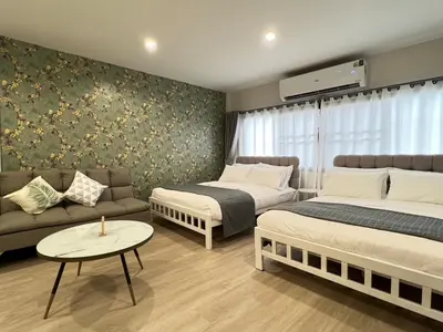 a living room with two beds and a couch at New Apt, Near Siam Paragon, 2 Min to BTS 1BR,4Pax in Bangkok