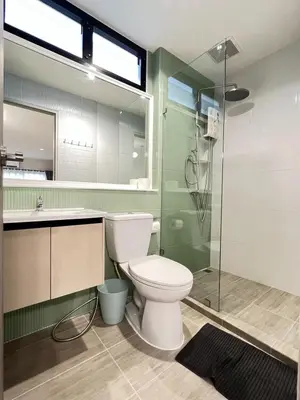 a bathroom with a toilet and a glass shower at New Apt, Near Siam Paragon, 2 Min to BTS 1BR,4Pax in Bangkok