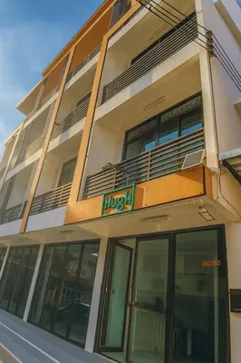 a large building with a hicks sign on it at Hug14 Hotel in Ban Bang Toei (1)