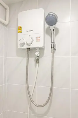 a shower in a bathroom with a shower head at Hug14 Hotel in Ban Bang Toei (1)