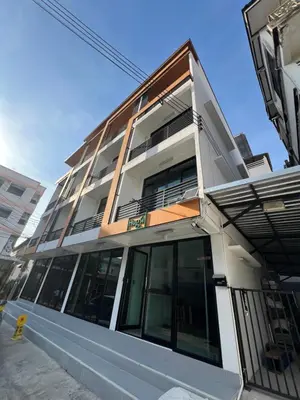 a white building with a lot of windows at Hug14 Hotel in Ban Bang Toei (1)