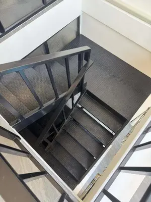 an empty stairwell in a kitchen with metal risers at Scandi Haus near ChinaTown in Bangkok