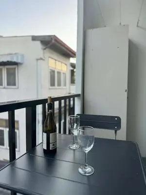 a bottle of wine and two glasses on a table at Scandi Haus near ChinaTown in Bangkok