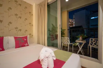 a towel animal sitting on a bed in a room at Taradii Boutique in Bangkok