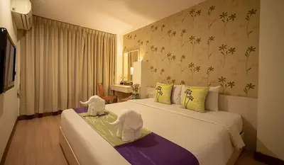 two stuffed elephants sitting on two beds in a hotel room at Taradii Boutique in Bangkok
